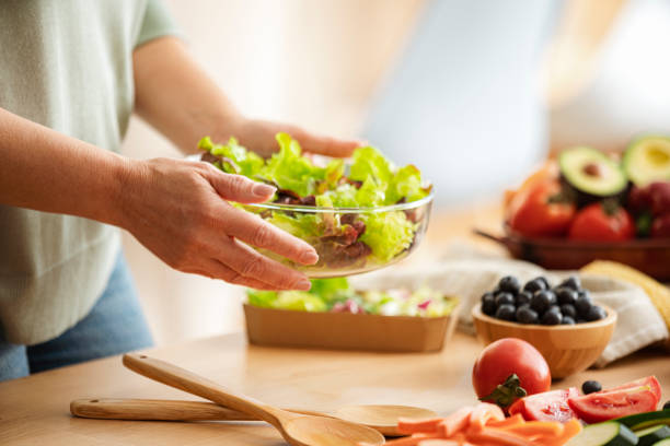 istock Hands holding healthy organic vegetables salad bowl 2150117106
