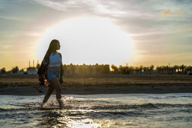 Attractive woman on beach at sunset