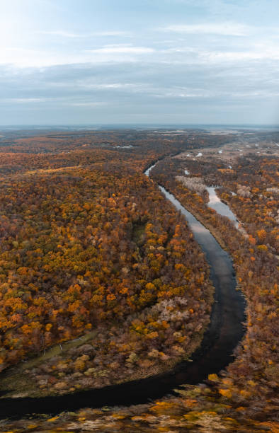 istock Autumn aerial river valley in woods panorama 2150117594