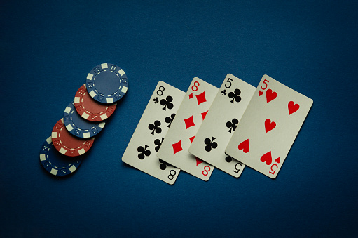 Luck in a casino game with a winning combination of two pairs. Playing cards and chips are laid out in a poker club on a blue table.