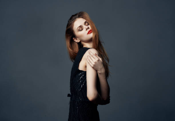 istock red-haired lady in a black dress gesturing with her hands hugs emotions makeup model 2150120144