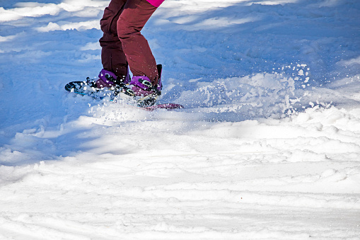 close-up of a snowboarder going down the slope. safe active recreation