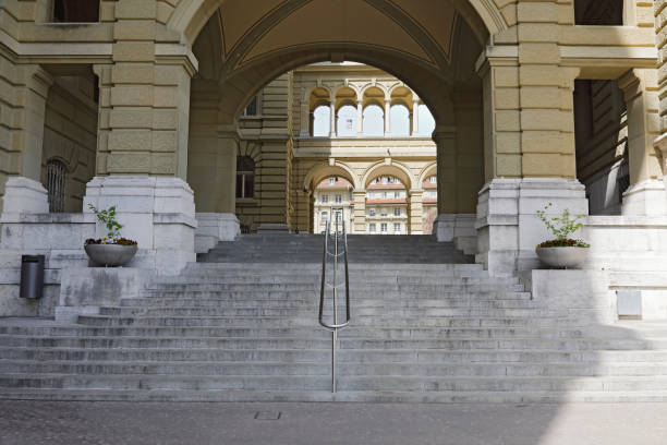 Bern, Switzerland - April 22, 2019: The broad staircase leads slightly upwards through the parliament building to the square.