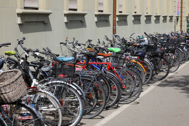 Bern, Switzerland - April 22, 2019: There are bicycles parked on the pavement at the wall of the building. Bicycles are an important means of transport in this city.