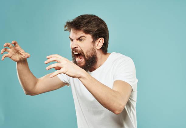 istock Aggressive man emotions and stress irritability blue background 2150123662