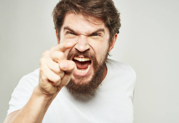 istock Aggressive man yells against a light background and gestures with his hands cropped view 2150124134