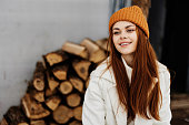 Happy young woman firewood for the stove price nature rest winter holidays