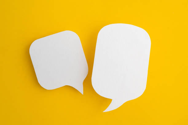 istock Conceptual image about communication and social media, customer feedback, real blank white speech bubble paper cut on grunge yellow color background 2150127391