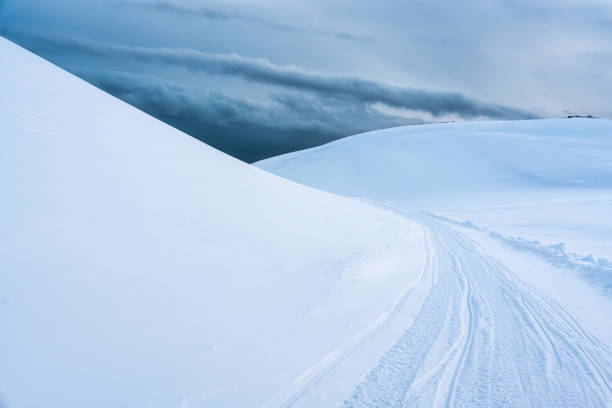 White glacier mountain with snow covered and snowmobile trail on summit in winter at Iceland