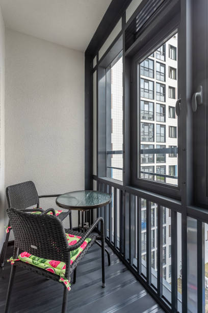 istock Balcony of an apartment building with chairs and a table. 2150127740