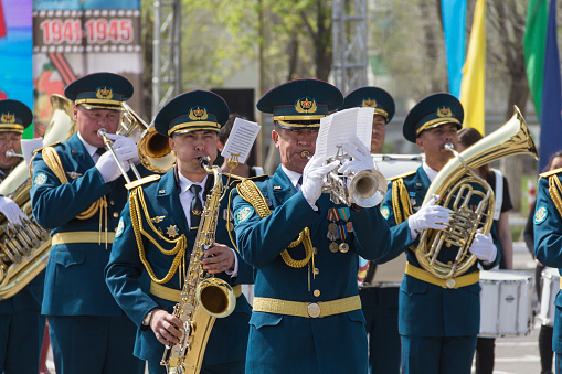 The Kazakh military band plays at the parade. The military band plays trumpets and saxophone. Holiday May 7th.