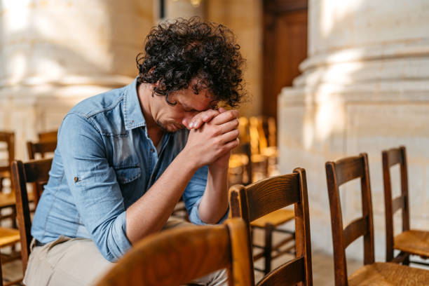 istock Young Man Praying In The Church In Paris 2150128451