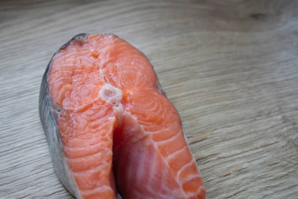 Trout steak lying on a cutting board close-up.
