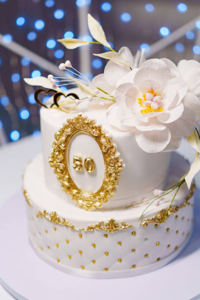 pink cake with golden roses as decorations