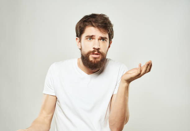 istock Man touches face with hands emotions model light background 2150131593
