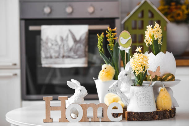 istock Happy Easter. Spring yellow hyacinth flowers in an egg-shaped vase, chicken chicks on a white table. In the background is a white Scandinavian-style kitchen. Easter decor in the house. 2150131939