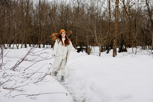 cheerful woman Walk in winter field landscape outdoor entertainment Lifestyle. High quality photo