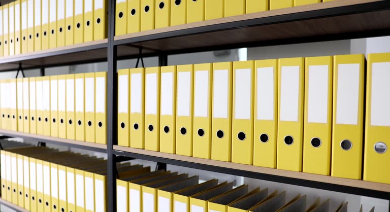 Bookcase with lot of yellow folders with documents in archive 4k movie slow motion