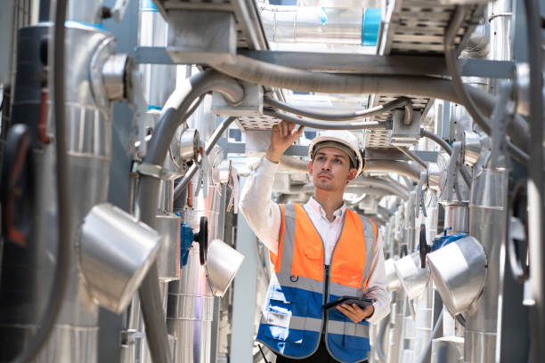 istock Engineers are inspecting a large building or industrial facility's cooling system for the air conditioning on rooftop building. 2150134113