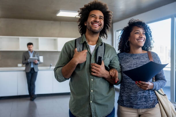 istock Couple visiting empty apartment for sale while real estate agent standing in background 2150134563