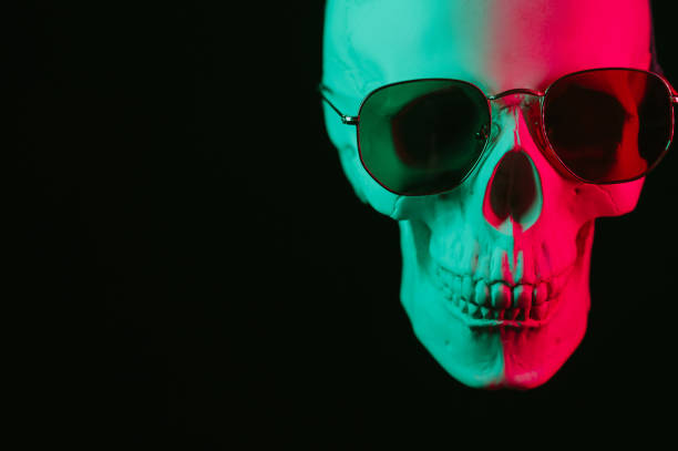 istock human skull wearing sunglasses with pink green neon light 2150135331