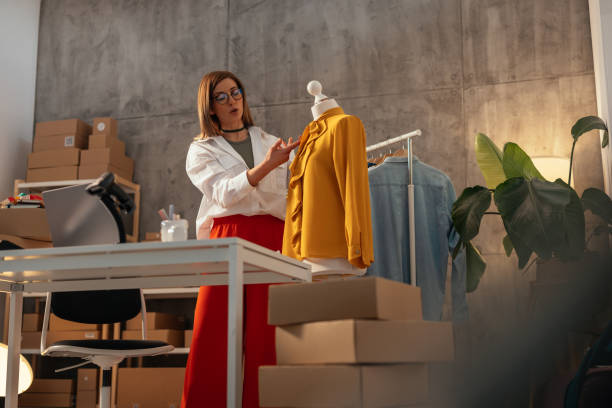 istock Fashion designer adjusting yellow blouse 2150137637