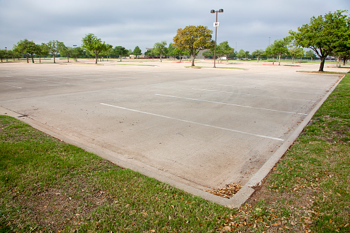 Very large empty concrete parking lot.