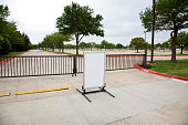 Large vacant parking lot with blank sign