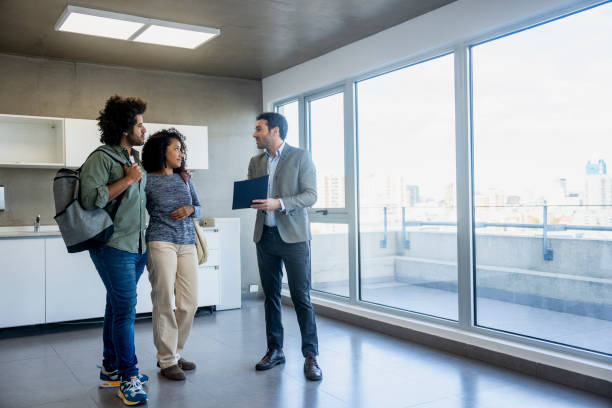 istock Real estate agent showing empty apartment to couple 2150138538