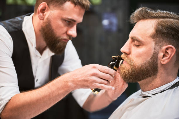 istock Professional hairdresser shaping thick beard. 2150140953