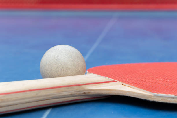 istock angle view pingpong racket and ball and net on a blue pingpong table at horizontal composition 2150142359