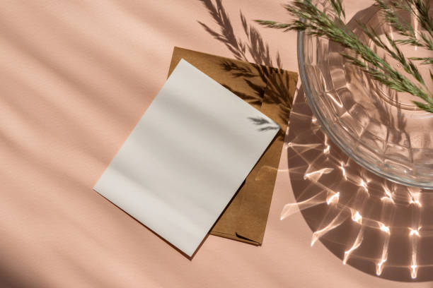 istock Blank paper card and envelope mockup with copy space on peach color color background with aesthetic natural sun light shadows. Feminine business brand template in trendy color 2024 2150143167