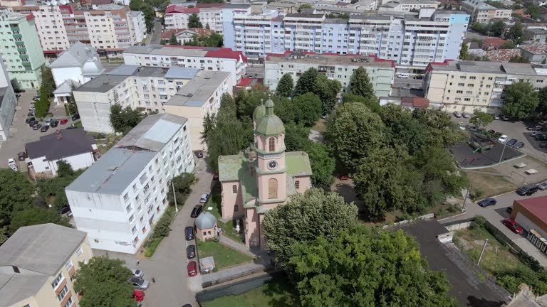Roman, Neamt County, Romania - Armenian Church Towers - Orbit Drone Shot