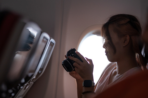 Female traveler checking photographs in the camera