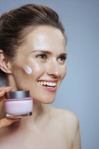 istock smiling modern woman with cosmetic cream jar 2150145450
