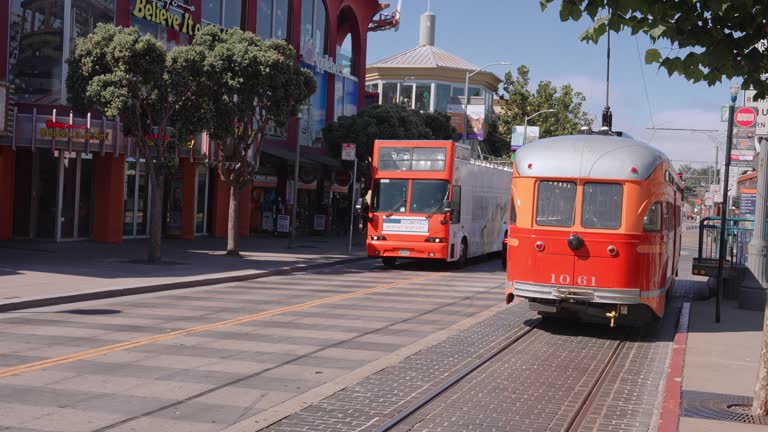 Classic view of historic traditional Cable Cars riding on famous California Street in morning light at sunrise