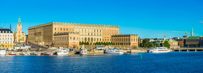 Warm light of sunrise illuminating of the historic Kungligaslottet Royal Palace on Gamla Stan in the heart of Sweden's picturesque capital city.