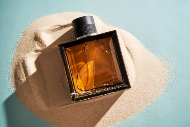 istock A bottle of perfume on a background of sand. 2150147067