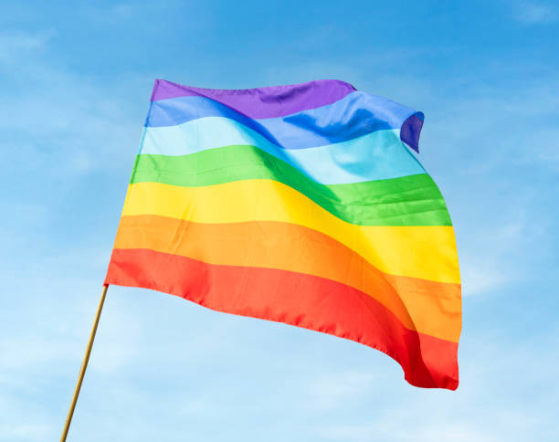 istock LGBT flag on in front of pretty blue sky 2150147727
