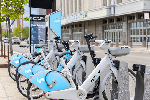 Chicago, IL, USA - April 25, 2024: Divvy bikes locked up at a rental kiosk outside of the United Center. Divvy recently released e-bikes to their fleet with locations all over the city.