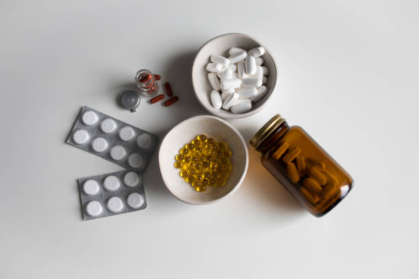 istock Many different pills and capsules on white background 2150149000