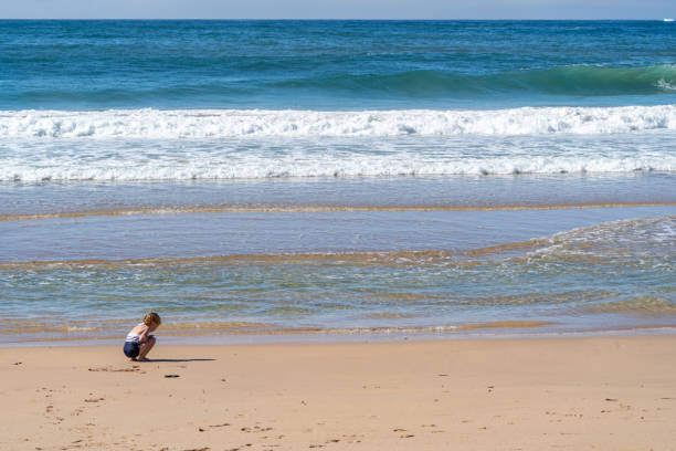 istock Young Girl Playing at a Beautiful White Sand  Beach in Eastern Australia 2150149009