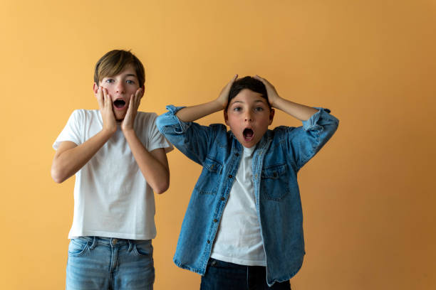 istock Two surprised children with their hands on their faces. 2150149715