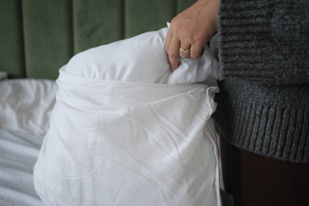 istock Woman Puts Pillow Into Pillowcase. 2150150049
