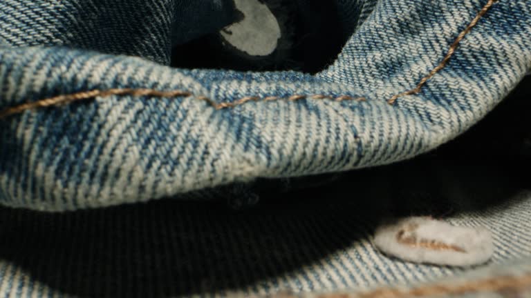 Blue textile jeans cloth texture close-up macro. Fashion fabric multicolor. Cotton casual clothes