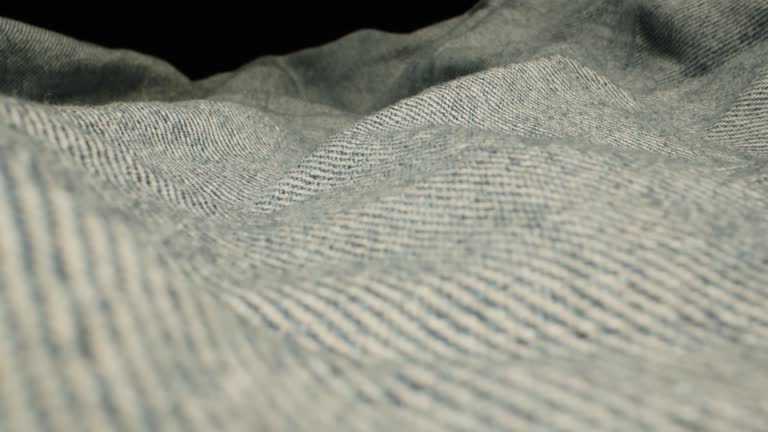 Blue textile jeans cloth texture close-up macro. Fashion fabric multicolor. Cotton casual clothes