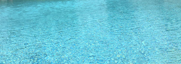Ripple Blue Water Surface In Swimming Pool With Reflection Of Natural Sun Light