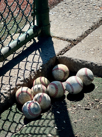 group of used baseballs