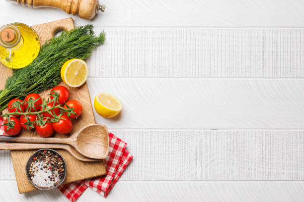 istock Cooking scene: Cherry tomatoes, herbs and spices on table 2150155522