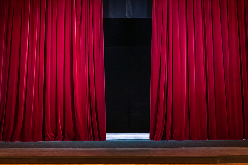Close-up of a closed red velvet curtain in theater